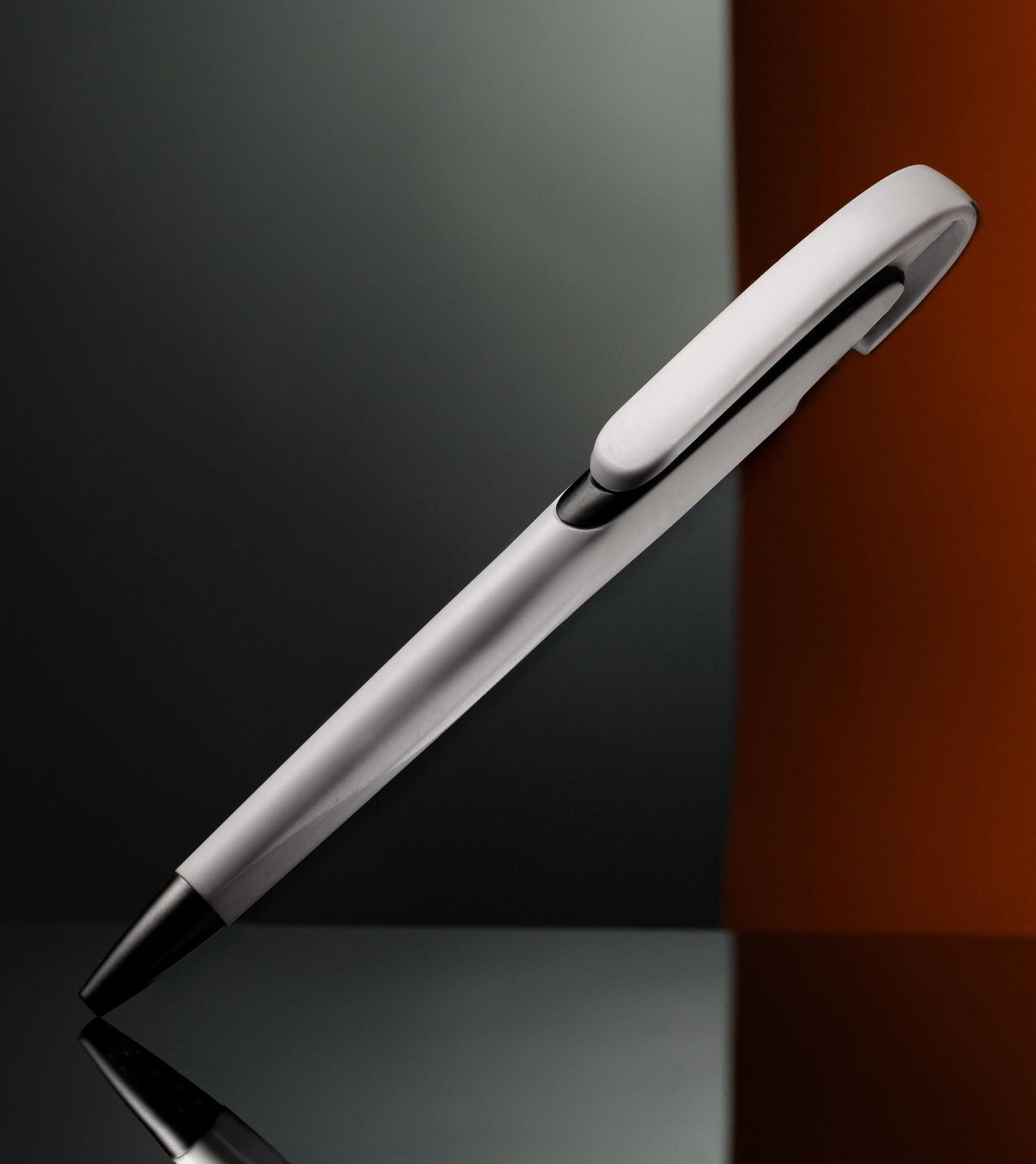Plain promotional pen on a lit surface